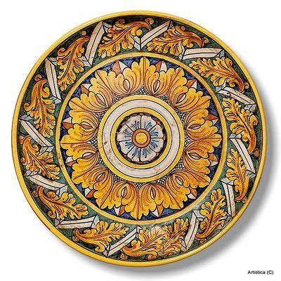 An Artisticly Designed Plate With Yellow Flowers And Leaves On The