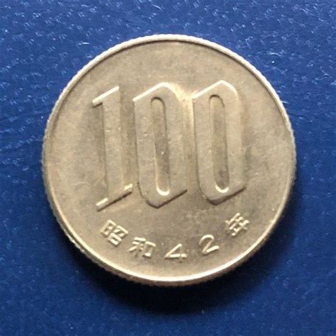 A Coin With The Number 100 On Its Front And Back Side Sitting On A