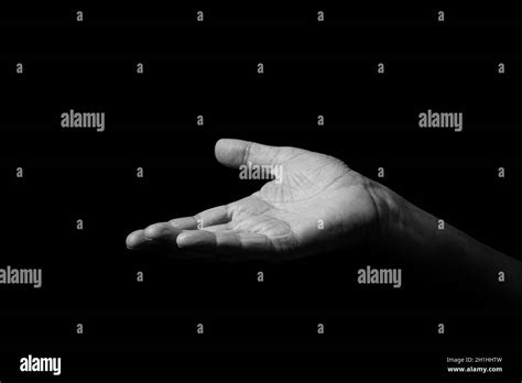 Black & white image of wrinkled male hand held out gesturing, with open ...