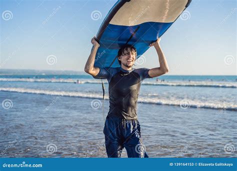 Man Carrying Surfboard Over His Head Close Up Of Handsome Guy With