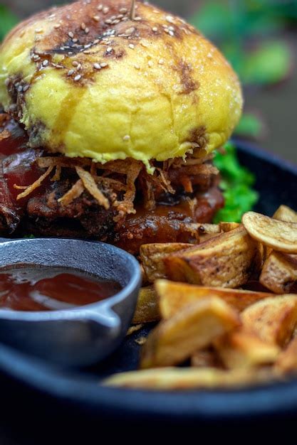 Premium Photo | A vegan burger with a side of fries and sauce. vegan food