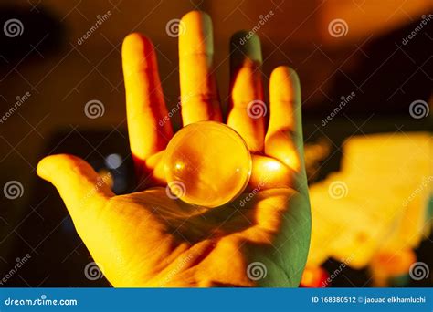 Close Up Of A Hand Holding A Crystal Glass Sphere Ball Transparent