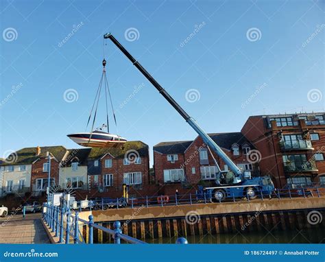 Crane Machine Lifting A Boat From Harbour Stock Image Image Of Marina