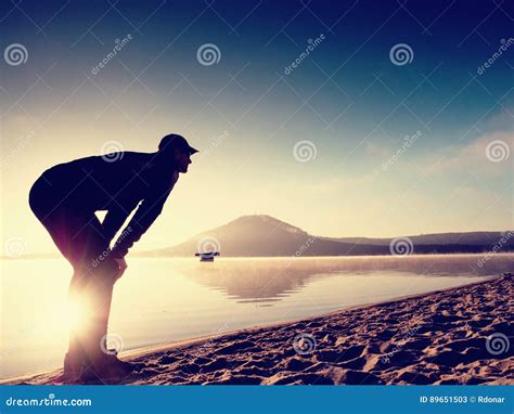 Man Exercising On Beach Silhouette Of Active Man Exercising And