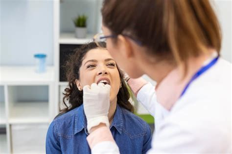 Premium Photo Female Patient Opening Her Mouth For The Doctor To Look