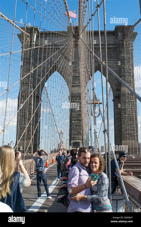 Young Couple Taking Selfie On Brooklyn Bridge Manhattan New York Usa