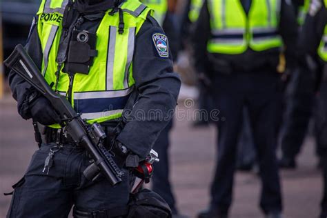 closeup   riot policeman hands holding  police gas gun stock image