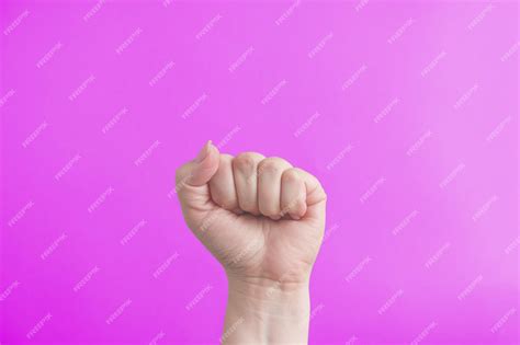 Premium Photo Female Fist On A Pink Background The Concept Of