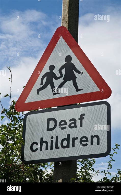 Dh Signpost Uk Roadsign Post Warning Of Deaf Children Near Road Stock