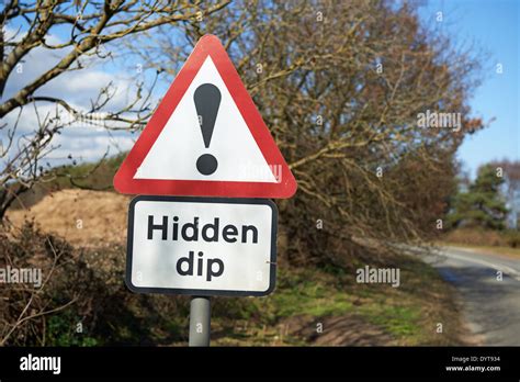 Hidden dip road sign Stock Photo - Alamy