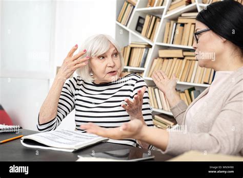 Attractive Mature Tutor And Woman Having Discussion Stock Photo Alamy