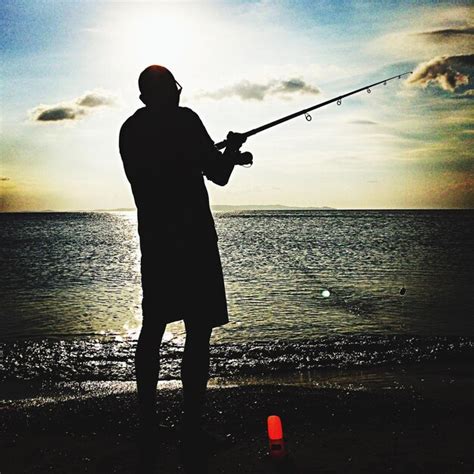 Premium Photo | Silhouette of man fishing