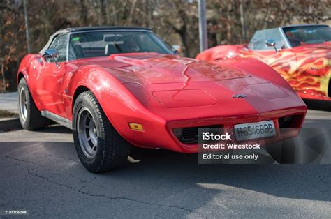 red thirdgeneration chevrolet corvette  american sports car parked