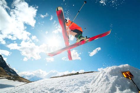 A Young Athlete Skier Does A Trick On A Snow Kicker Jump And Cross Skis