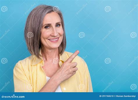 Photo Of Sweet Shiny Woman Dressed Yellow Shirt Pointing Finger Empty Space Isolated Blue Color