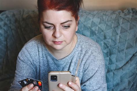 Premium Photo Red Haired Woman Holding Credit Cards And A Mobile Phone