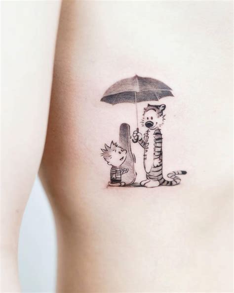 Calvin And Hobbe Tattoo Located On The Rib