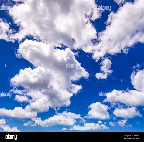 Blue sky background with fluffy white clouds beautifully shaped Stock Photo - Alamy