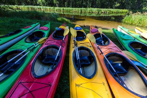 Colorful fiberglass kayaks tethered to a dock as seen from above ...