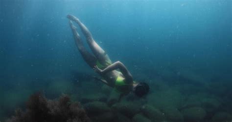 Attractive Woman In Bikini Dives In Transparent Fresh Water Lake Or Sea Underwater View