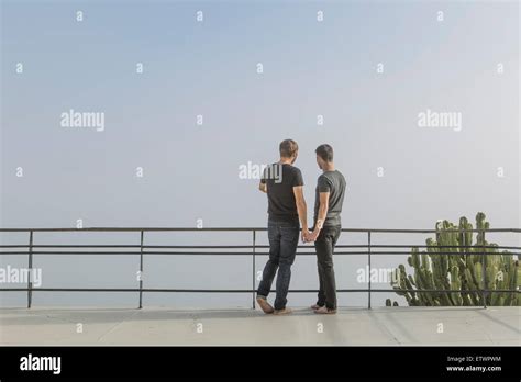 Gay Couple Standing On A Balcony Stock Photo Alamy