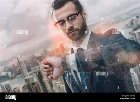 I should be there in time. Confident businessman in suit looking at his ...