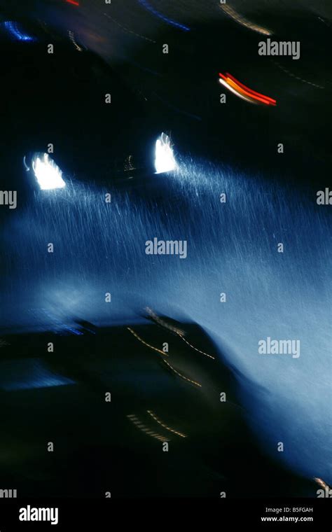 fast car driving in heavy rain at night in town Stock Photo - Alamy