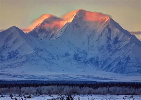 the mountains are covered in snow as the sun is setting over them and there is no image here to ...