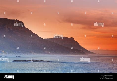 Camps Bay at sunset. A view of Camps Bay across the ocean at sunset Stock Photo - Alamy