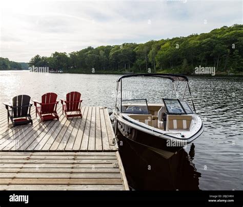 Boat dock and chairs, summer at the cottage Stock Photo - Alamy