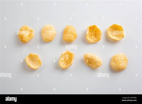 Potato Chips Falling Into Glass Bowl Isolated On White Background With