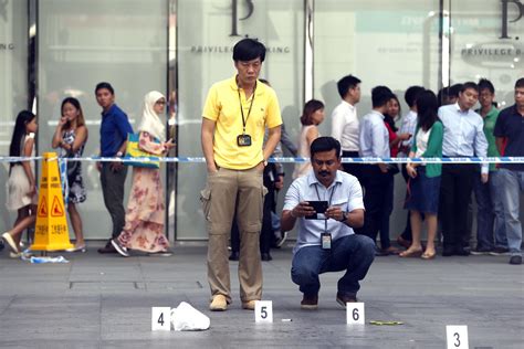 Stabbing in armed robbery stuns lunchtime crowd in Singapore's banking