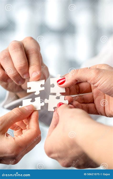 Four Hands Fitting Together Matching Interlocking Puzzle Pieces Stock