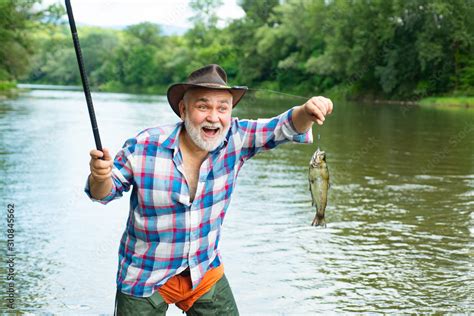 Bearded Man Catching Fish Male Hobby Against The Background Of The