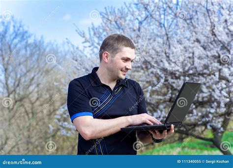 Young Man with Laptop Working Outdoors Stock Image - Image of online ...