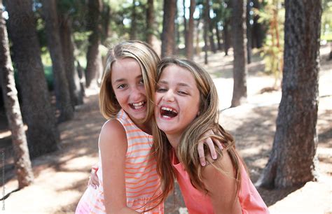 "Two Young Girls Laughing In A Park" by Stocksy Contributor "Dina Marie ...