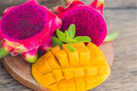 Sliced Dragon Fruit And Mango On An Old Wooden Background Stock Image