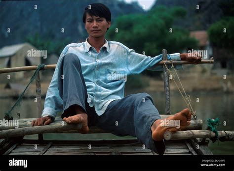 Man Rowing Boat With Feet Taken In Kenh Ga Ninh Binh Province