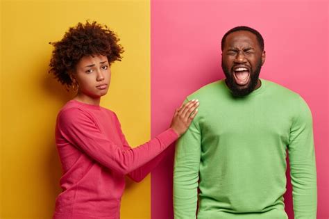 Free Photo Caring Woman Tries To Calm Husband Touches Shoulder And