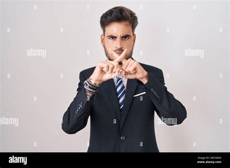 Young Hispanic Man With Tattoos Wearing Business Suit And Tie Rejection