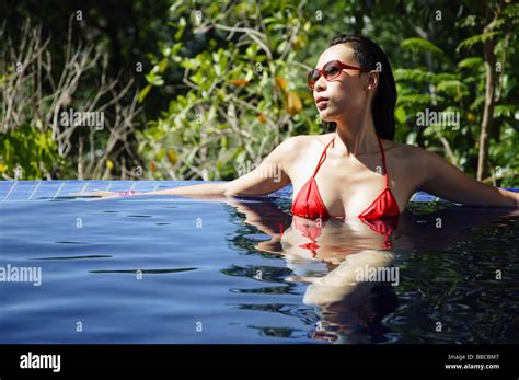 Woman In Red Bikini Sitting In Swimming Pool Stock Photo Alamy