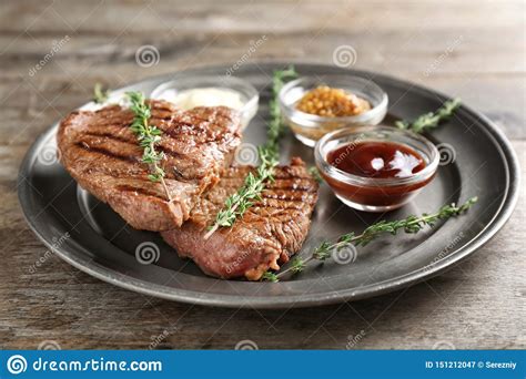 Tasty Grilled Steak With Different Sauces On Metal Tray Stock Image