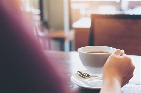 Premium Photo | Hand holding coffee cup