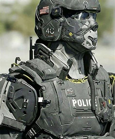 A Police Officer In Full Gear Is Standing On The Street