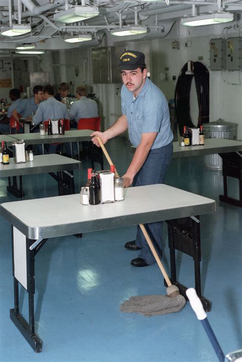 A Crew Member Swabs The Mess Deck Aboard The Nuclear Powered Aircraft