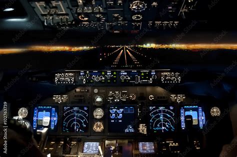 Final approach at night - landing plane flight deck view Stock Photo ...