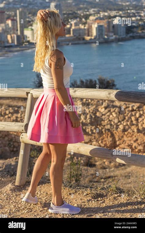 This Image Captures A Beautiful Blonde Woman On Vacation In Calpe Spain She Is Standing