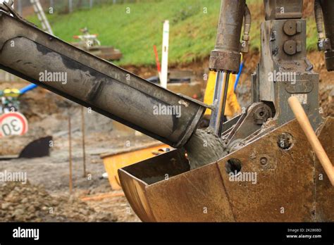 Liquid Concrete Is Filled Into The Grab By An Excavator Stock Photo Alamy