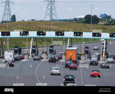 M6 TOLL MOTORWAY ROAD from above with cars approaching toll booths ...