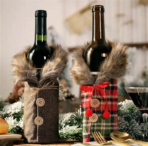 Two Bottles Of Wine Sitting On Top Of A Table Next To Christmas